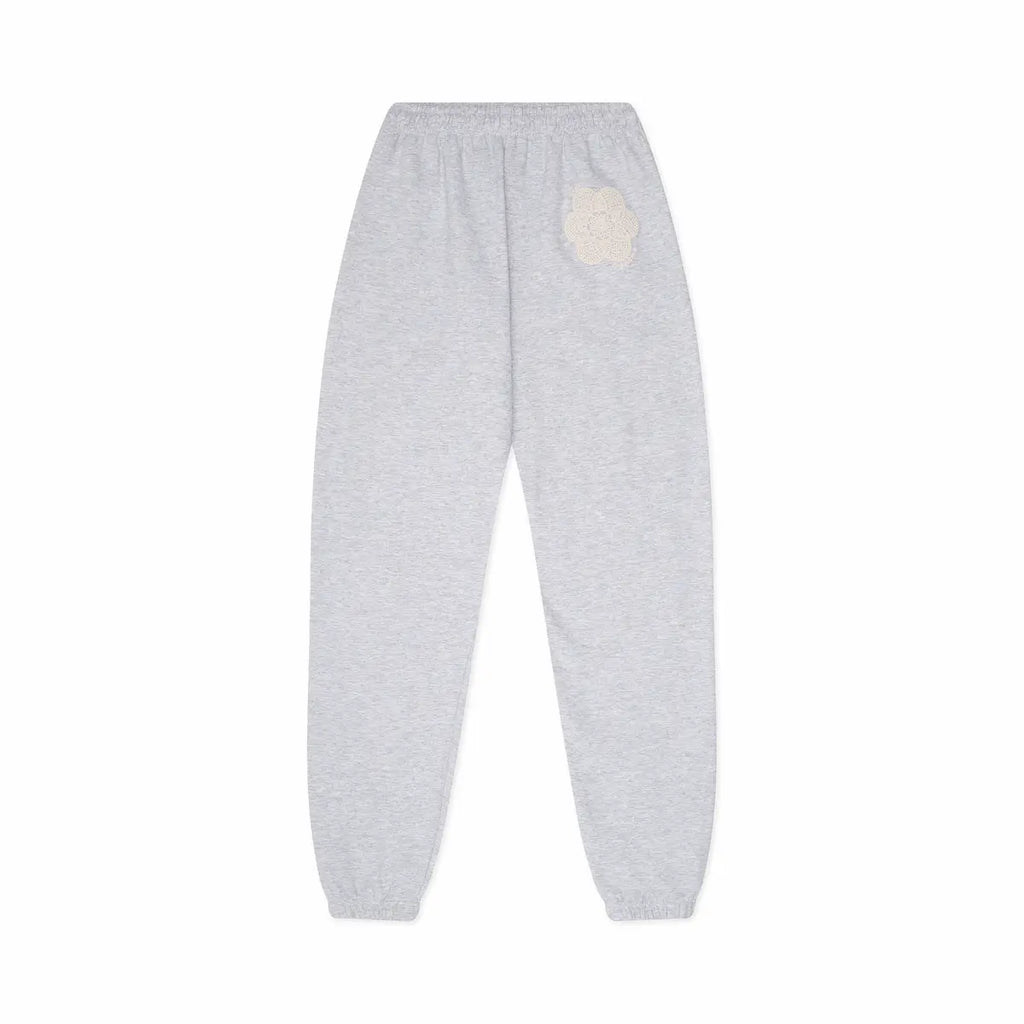 Gray sweatpants with a white doily design on a white background