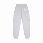Gray sweatpants with a white doily design on a white background