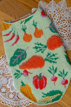 Embroidered fabric with vegetable pattern on a lace doily