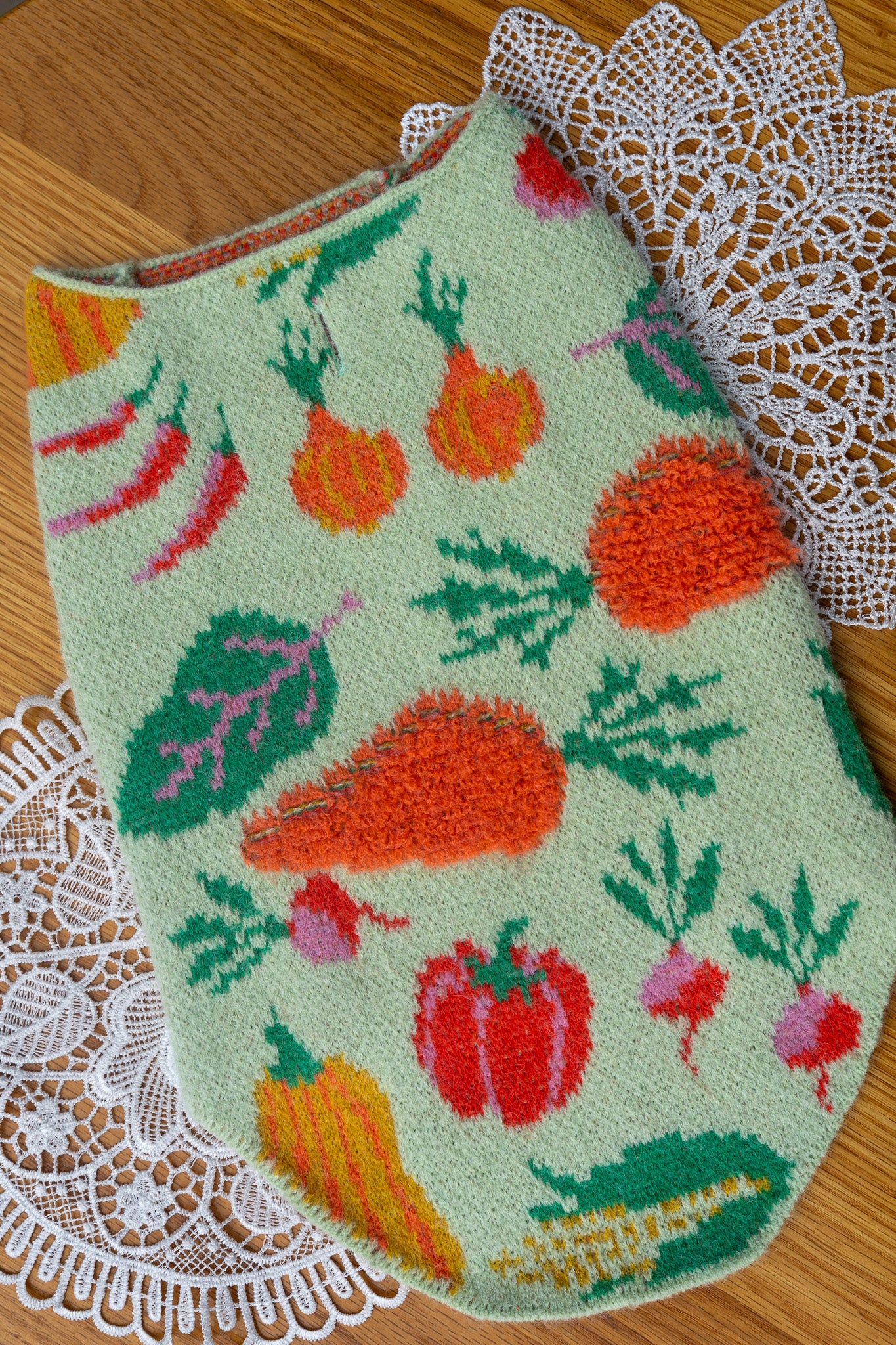 Embroidered fabric with vegetable pattern on a lace doily