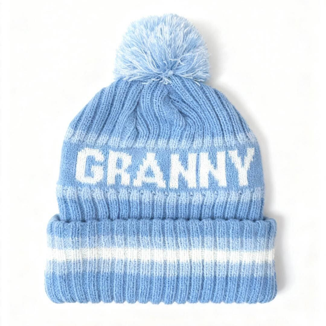 Blue and white winter beanie with pom on top and "GRANNY" across 