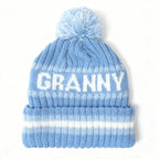 Blue and white winter beanie with pom on top and "GRANNY" across 