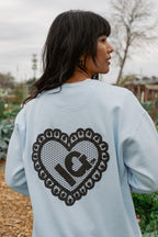 Blue light back view sweatshirt with a puff lace heart with IG in the middle