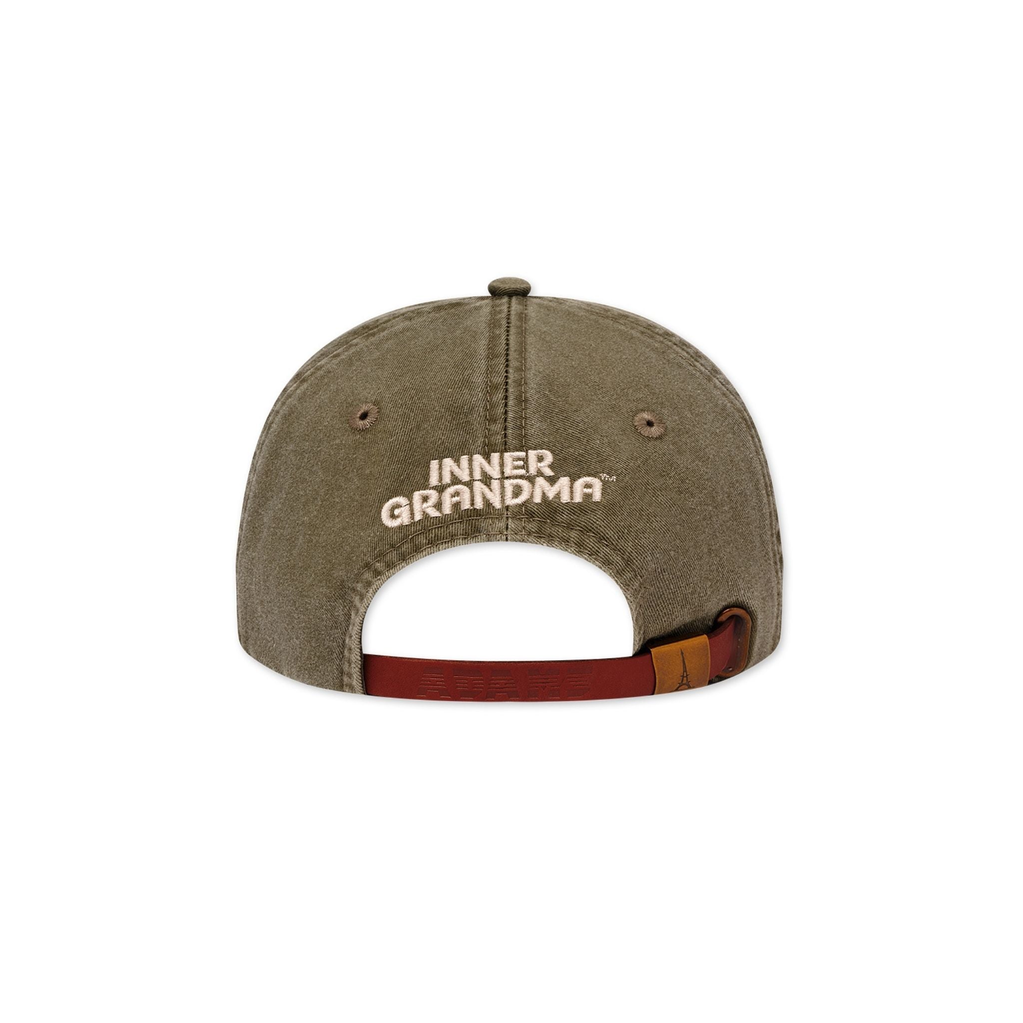 The back view of the olive green baseball hat with write "inner grandma" and a leather back strap with metal clasp. 