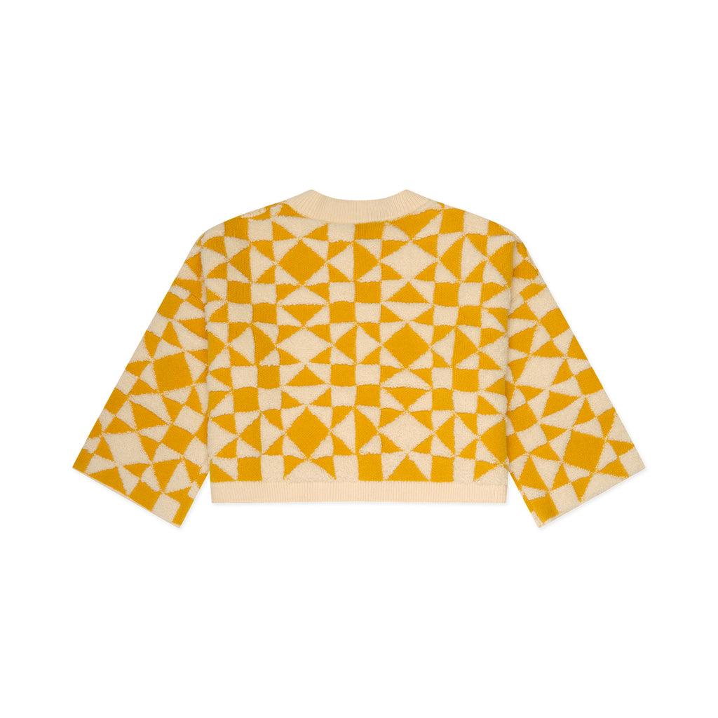 Yellow and white geometric patterned shirt on a white background