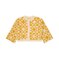 Yellow and white geometric patterned cardigan on a white background