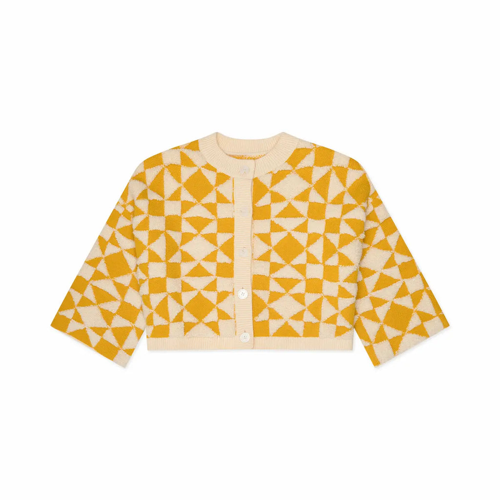 Yellow and white geometric patterned cardigan on a white background