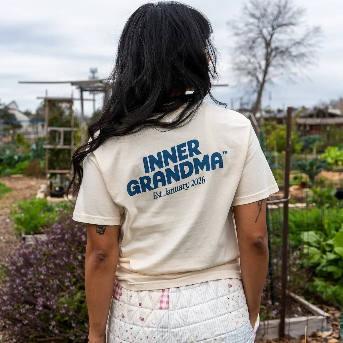 Person wearing a 'Inner Grandma' t-shirt in an outdoor setting