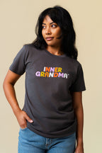 Person wearing a grey shirt with colorful 'Inner Grandma' lettering on the front.