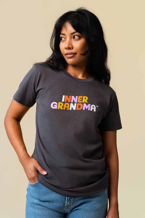 Person wearing a grey shirt with colorful 'Inner Grandma' lettering on the front.