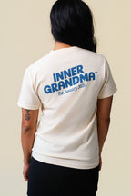 Back of person wearing a white t-shirt with a inner grandma printed on the back.