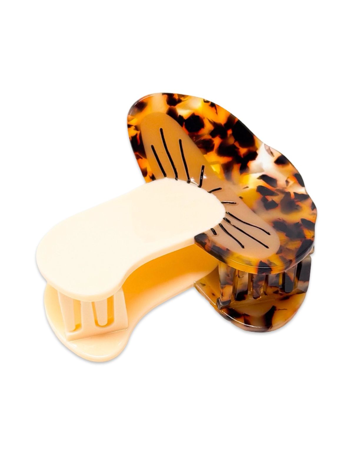 Tortoiseshell hair clip with a white barrette on a white background