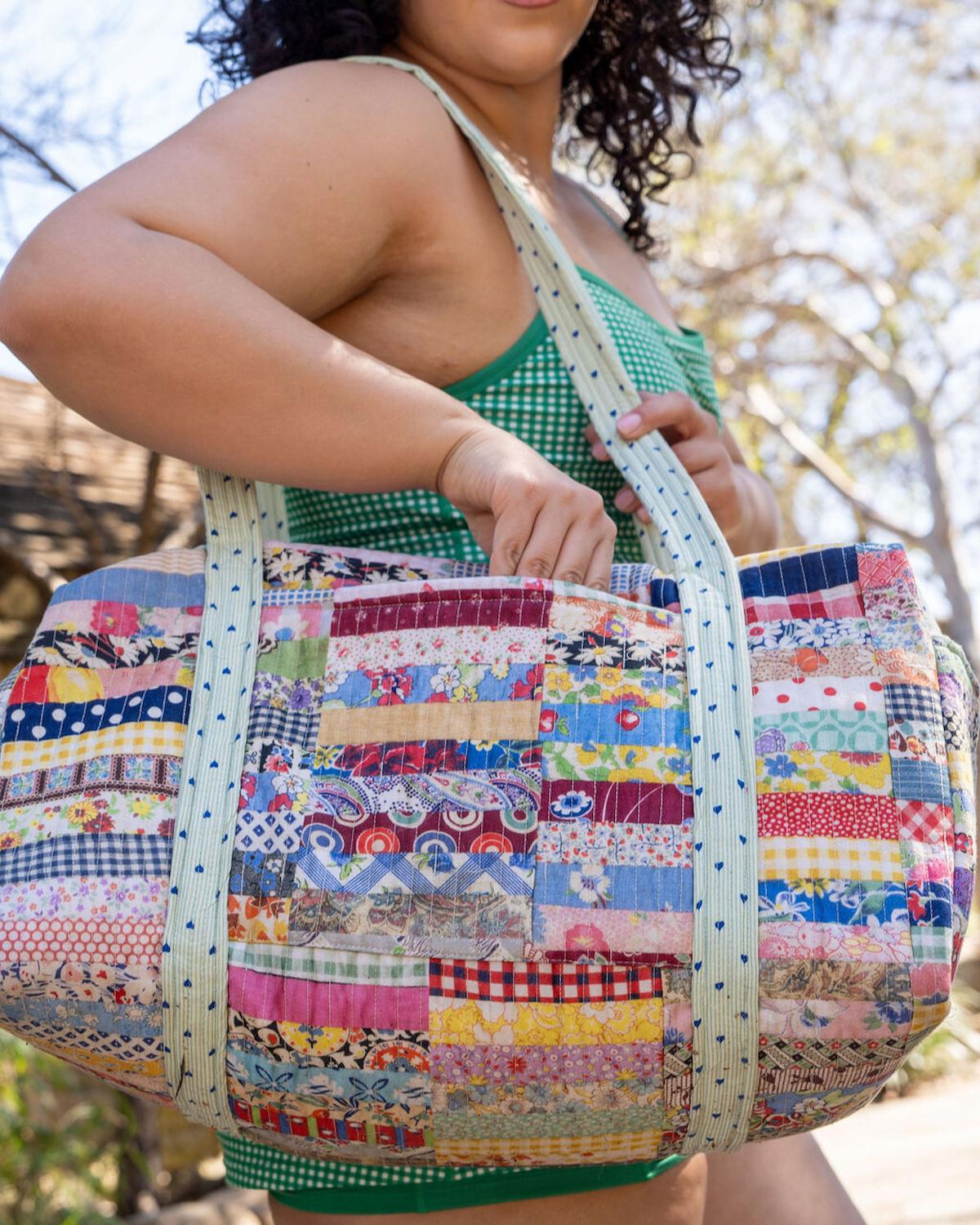 Person holding a colorful patchwork bag outdoors