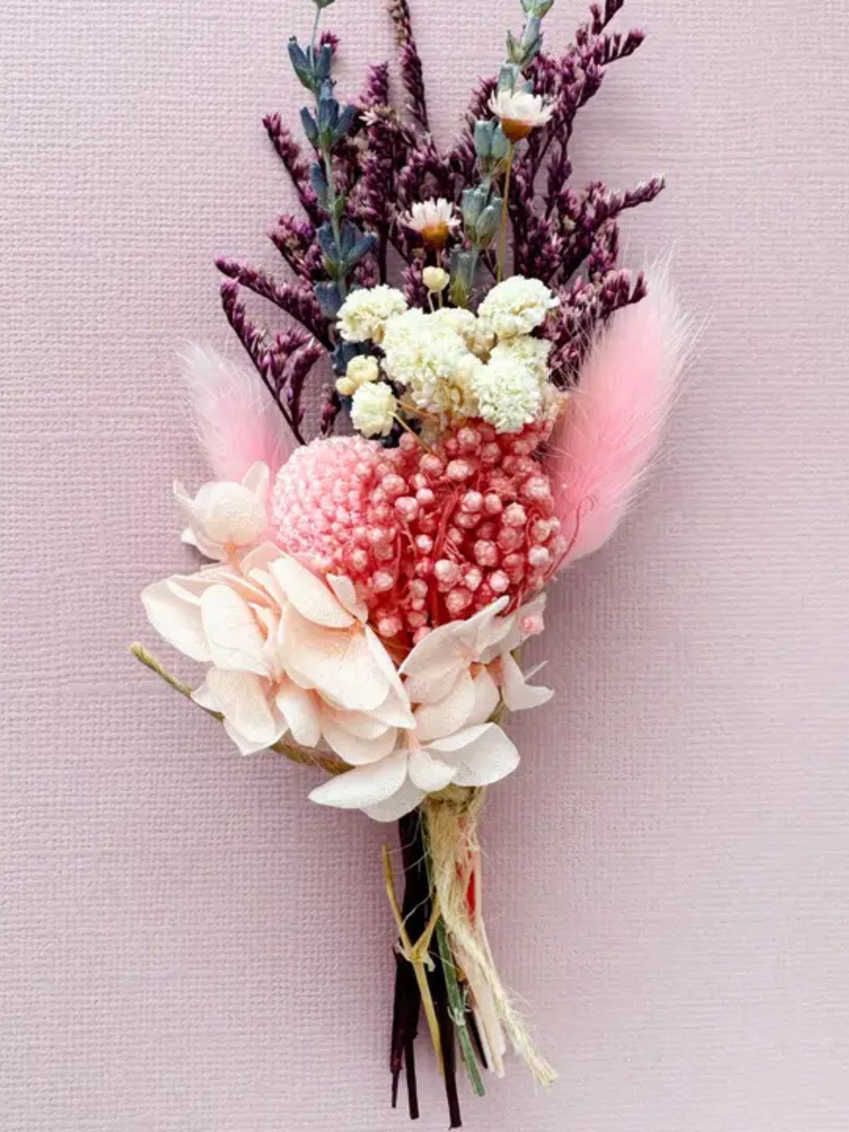 Floral arrangement with pink and white flowers on a light pink background