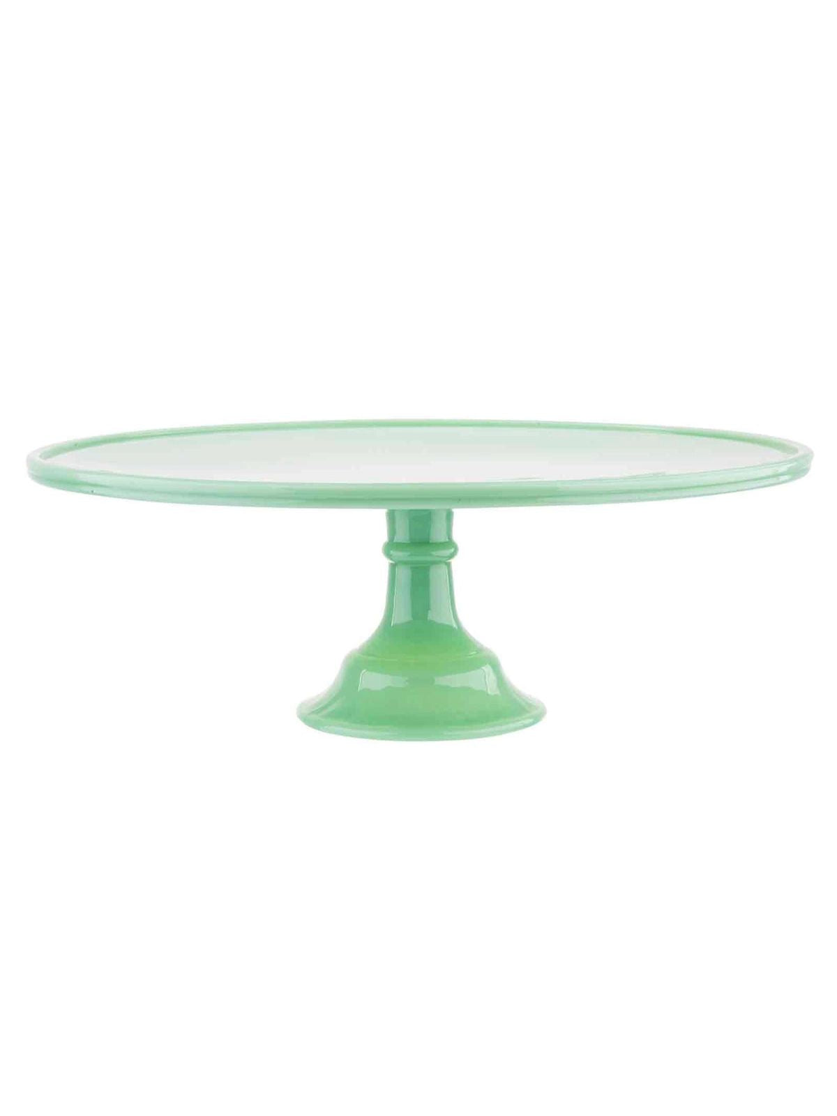 Green cake stand with a clear glass plate on a white background