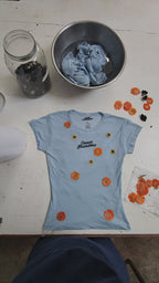 Short-sleeve light blue cropped baby tee shirt with floral pattern naturally dyed by flowers with "Inner Grandma" text