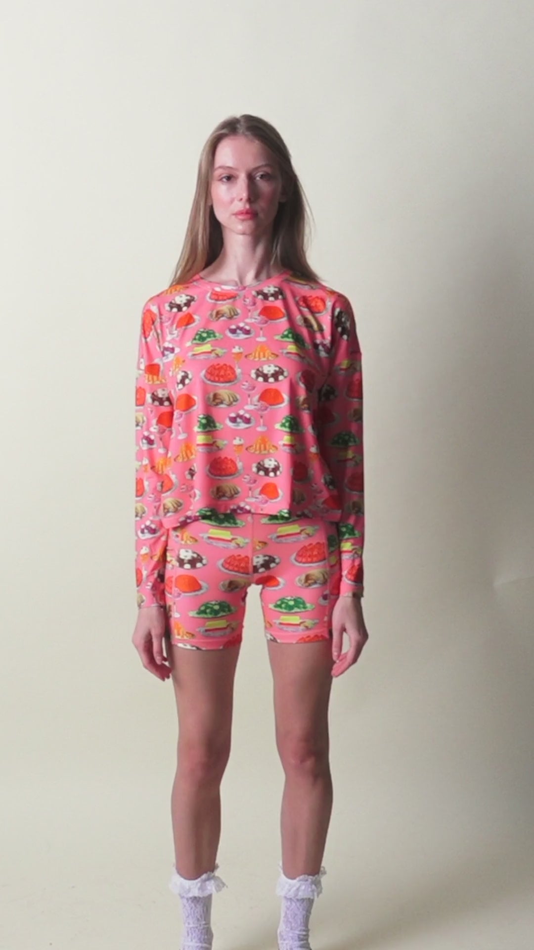Person in pink long sleeve shirt and short with gelatin dessert print 