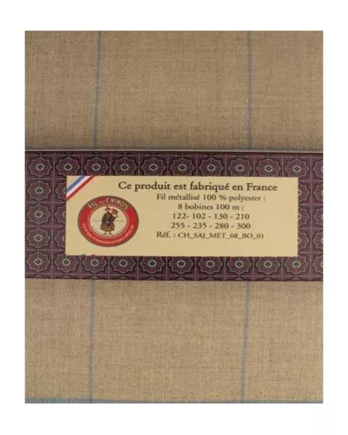 Fabric with a label indicating 'produced in France' on a brown and gray checkered background