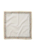 White napkin with colorful border on a white background