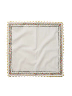 White napkin with colorful border on a white background