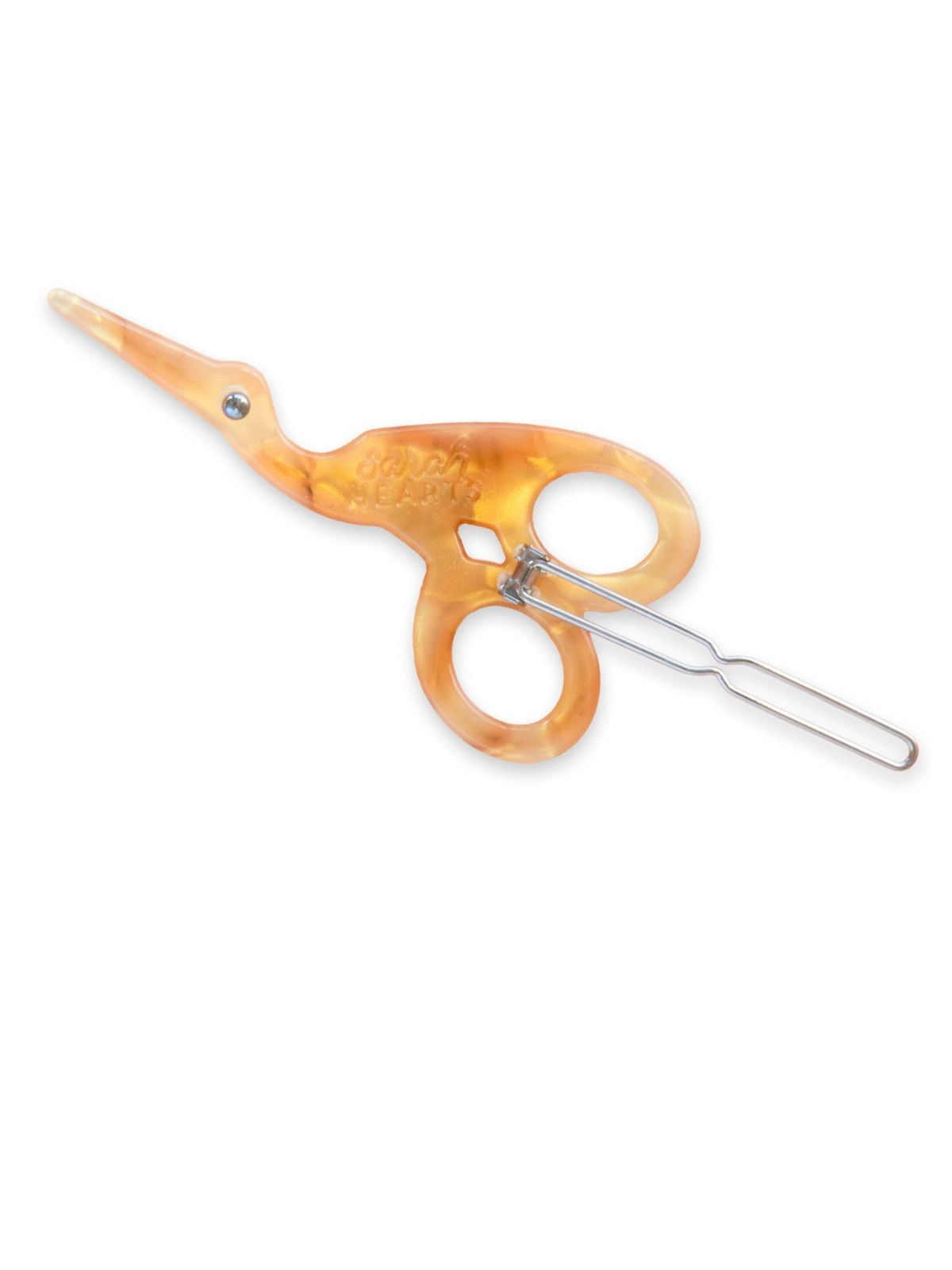 Decorative scissors with tortoiseshell handle on a white background