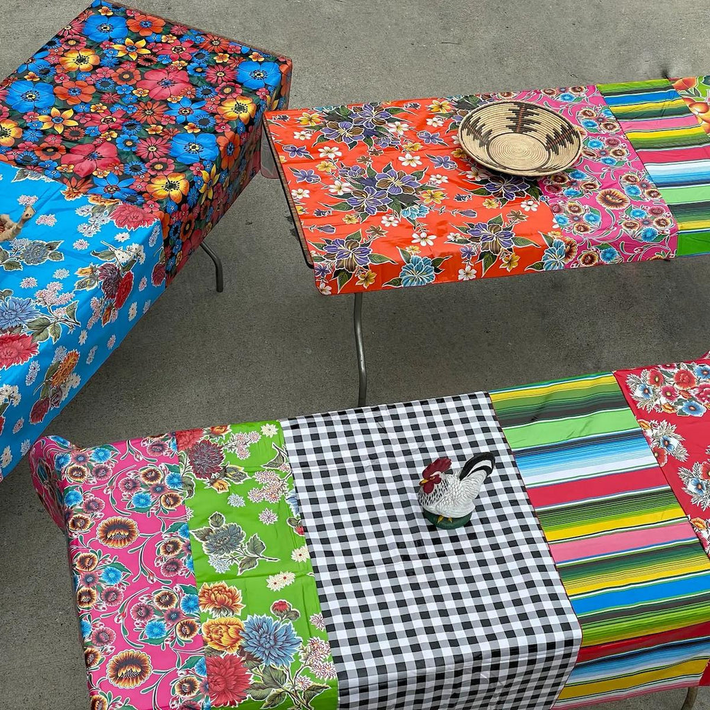 Colorful patterned tables with various designs on a gray surface