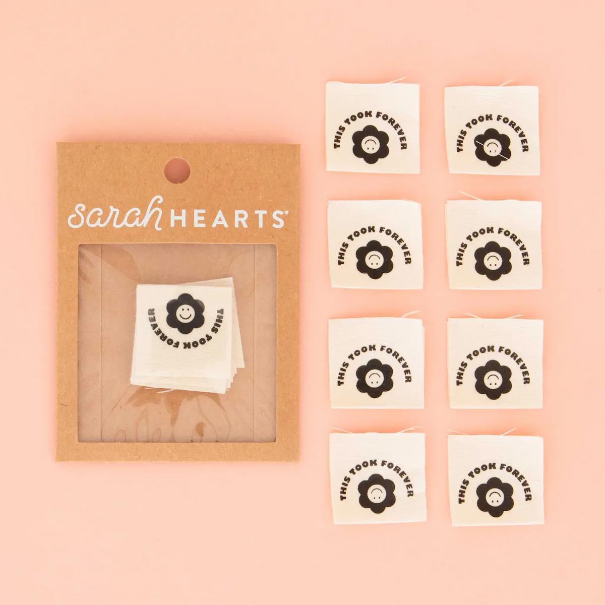 Packaging of 'sarah HEARTS' with decorative stickers on a pink background