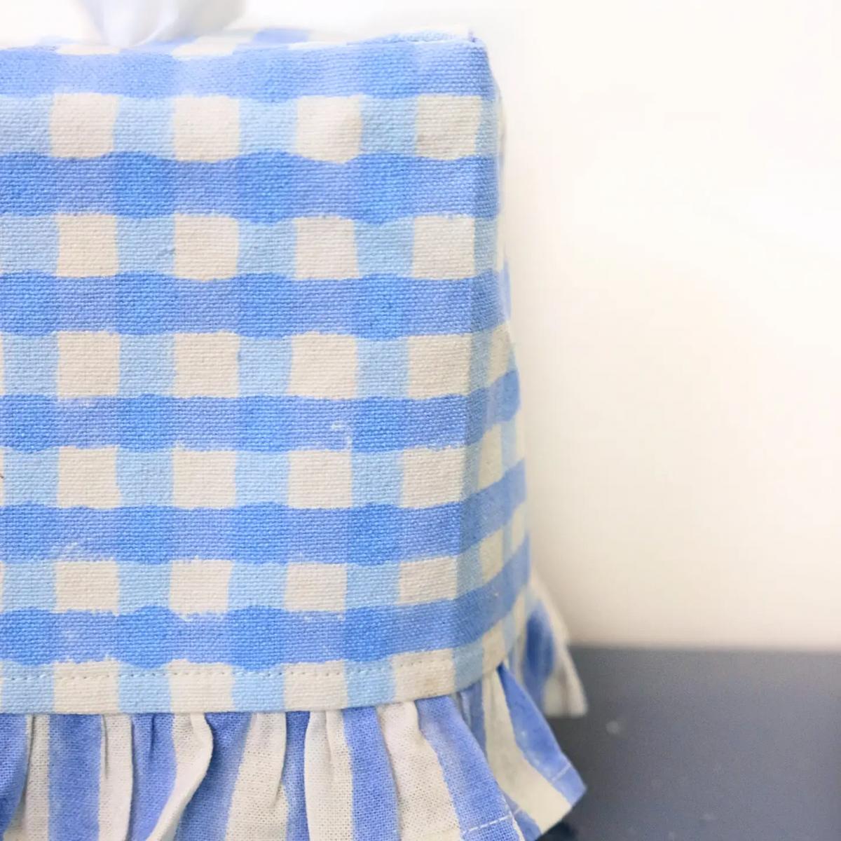Blue and white checkered tablecloth on a table with a blurred background