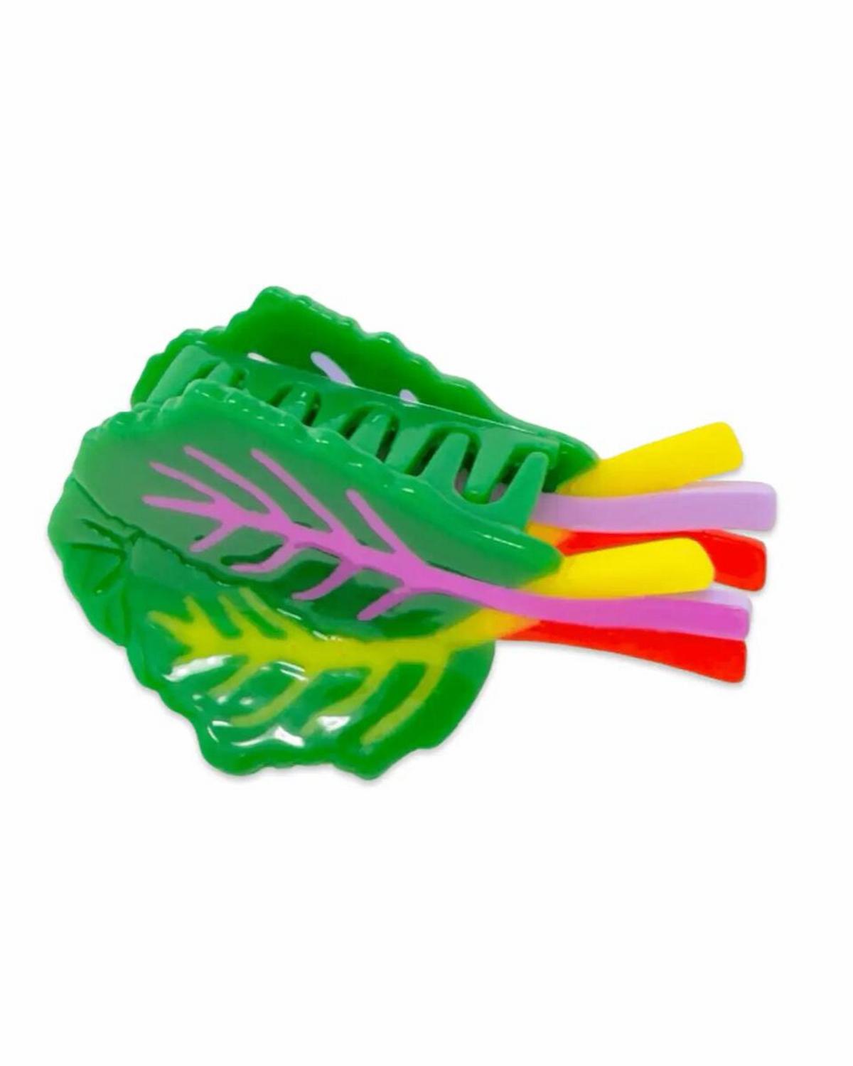 Green leaf-shaped holder with colorful straws on a white background