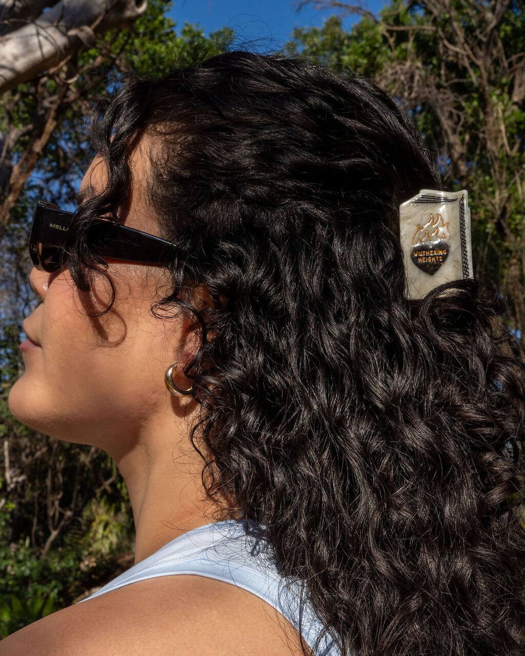 Woman with styled hair wearing sunglasses outdoors