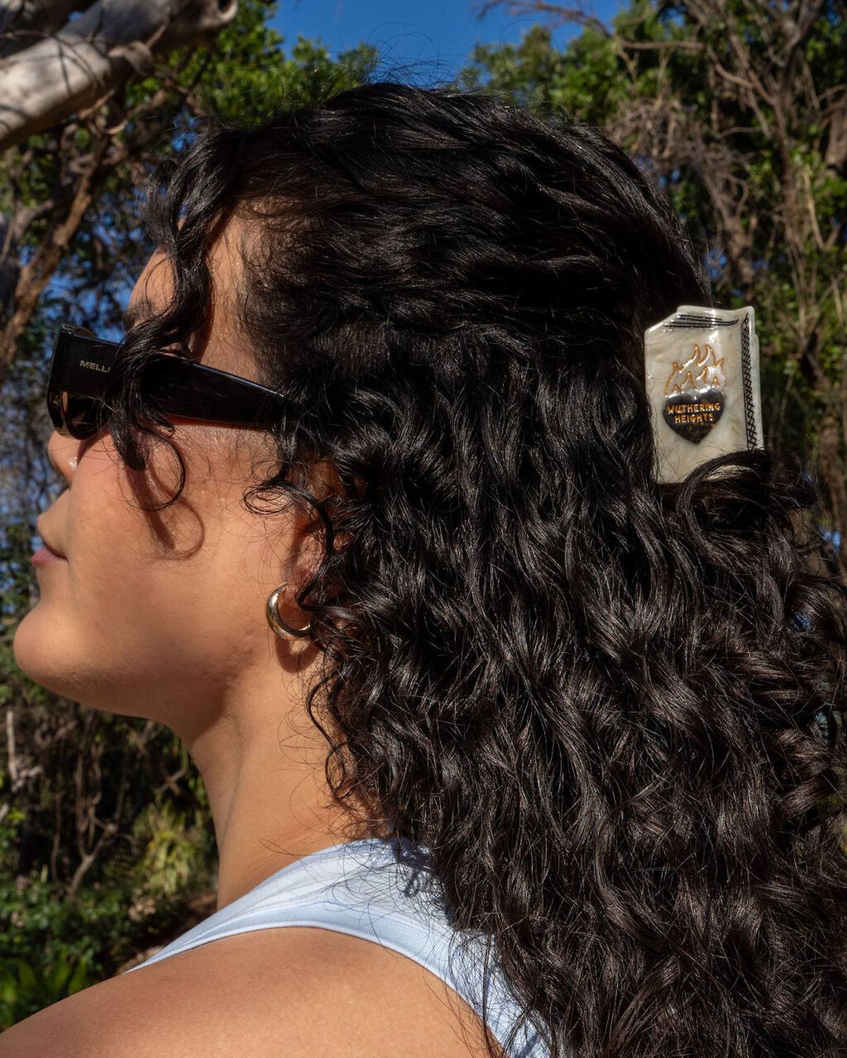 Woman with styled hair wearing sunglasses outdoors